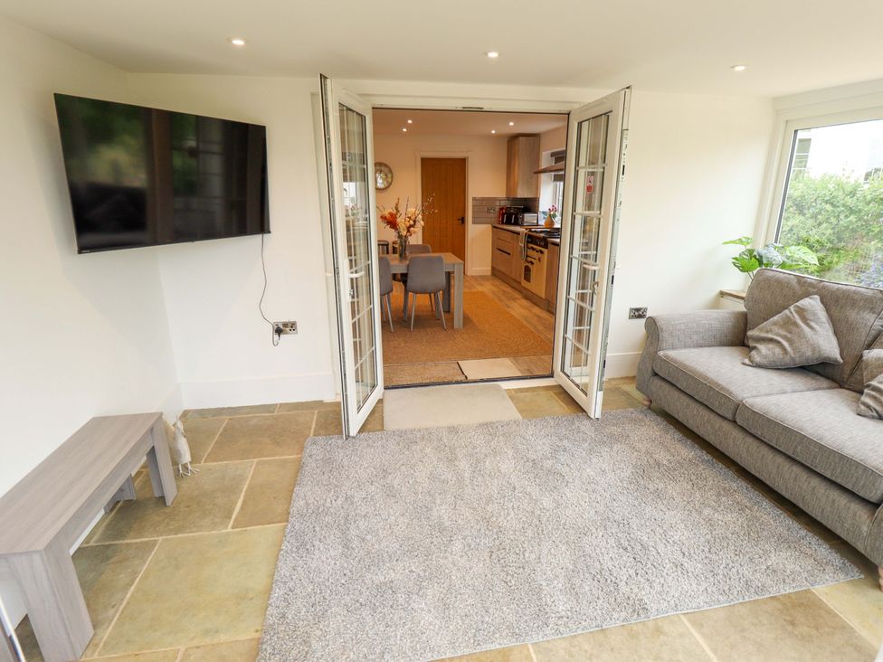A living room with a sofa and a TV at The Hen House