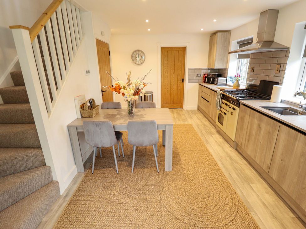 A kitchen with dining area and appliances at The Hen House