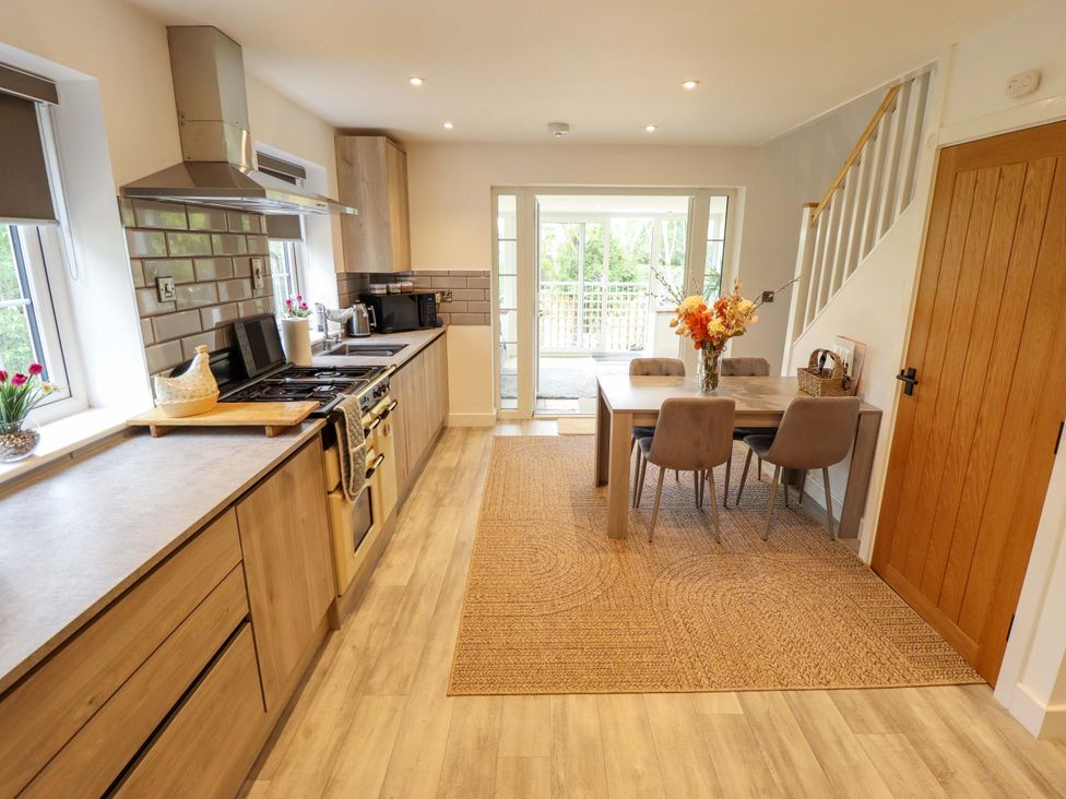 A kitchen with a dining table and chairs at The Hen House
