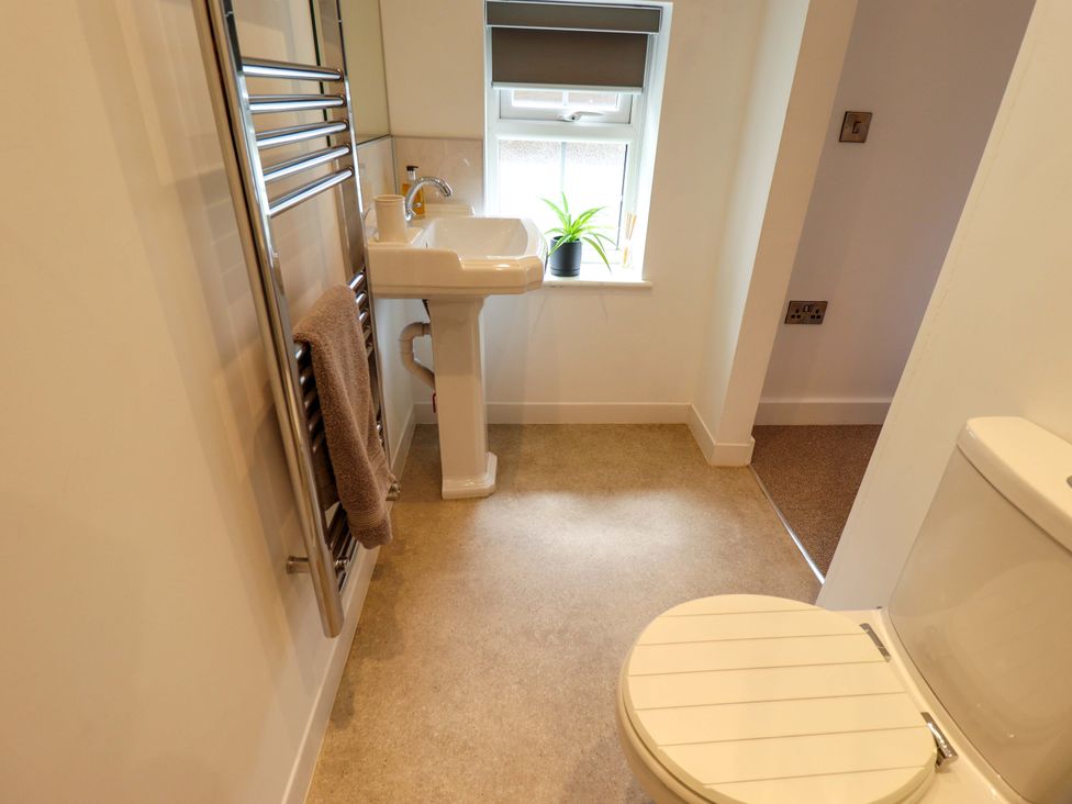 A bathroom with a sink and toilet at The Hen House