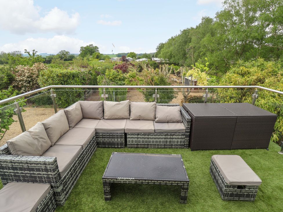 A sofa and coffee table on an outdoor patio at The Hen House 