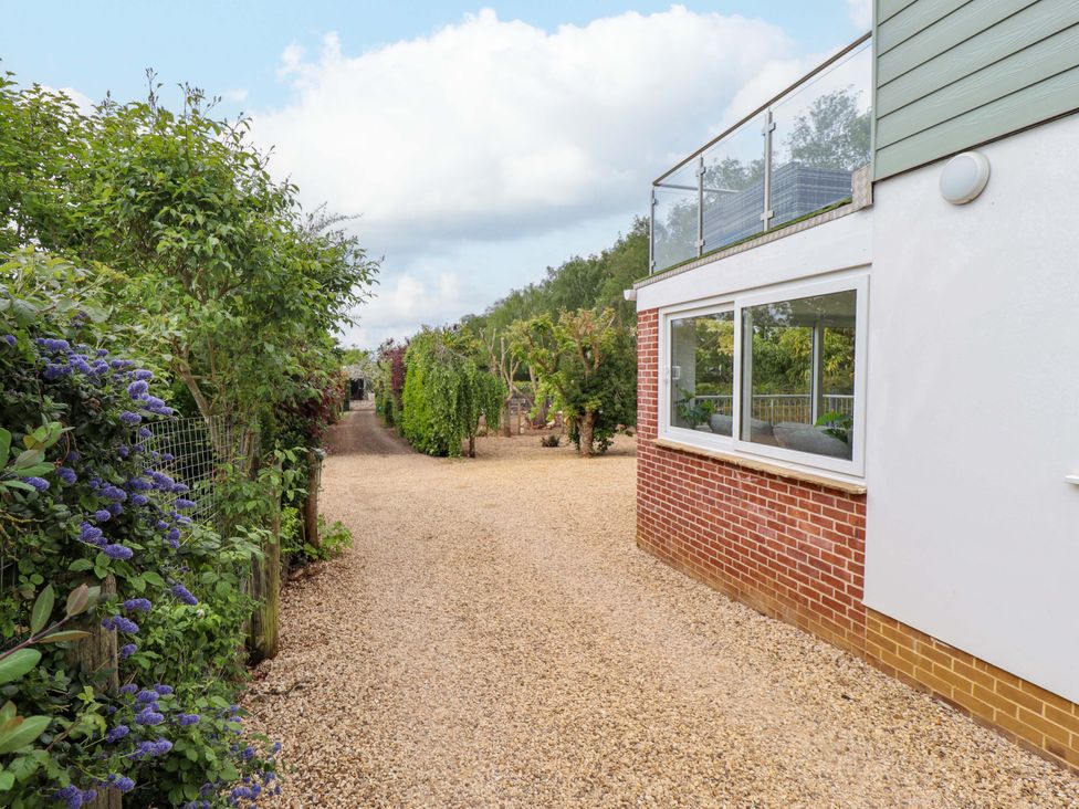A house exterior with a gravel path and plants at The Hen House 