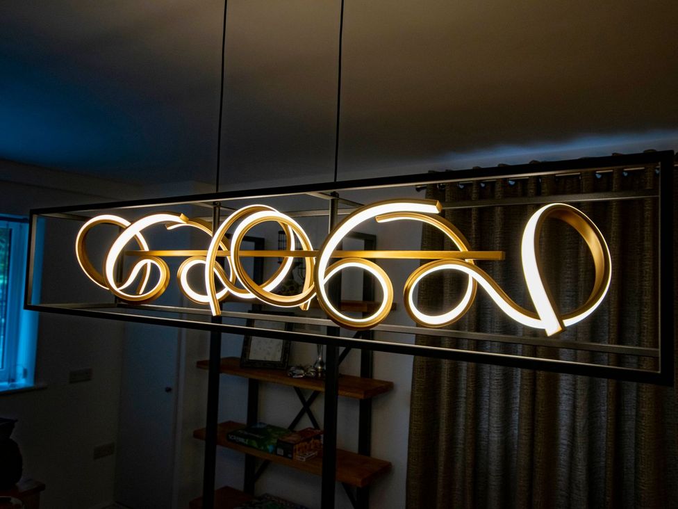 A hanging light fixture in a dining room at Seagull Shack Morfa Bychan
