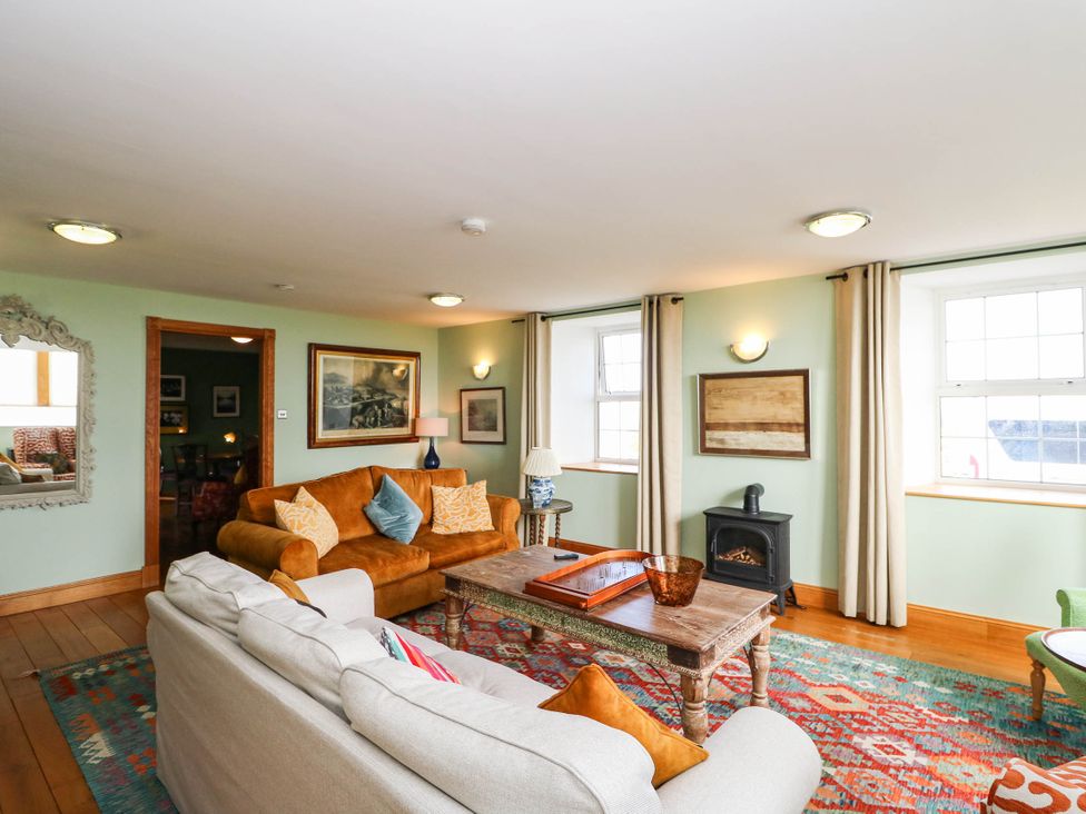 A living room with a sofa and coffee table at Old School House in Isle Of South Uist