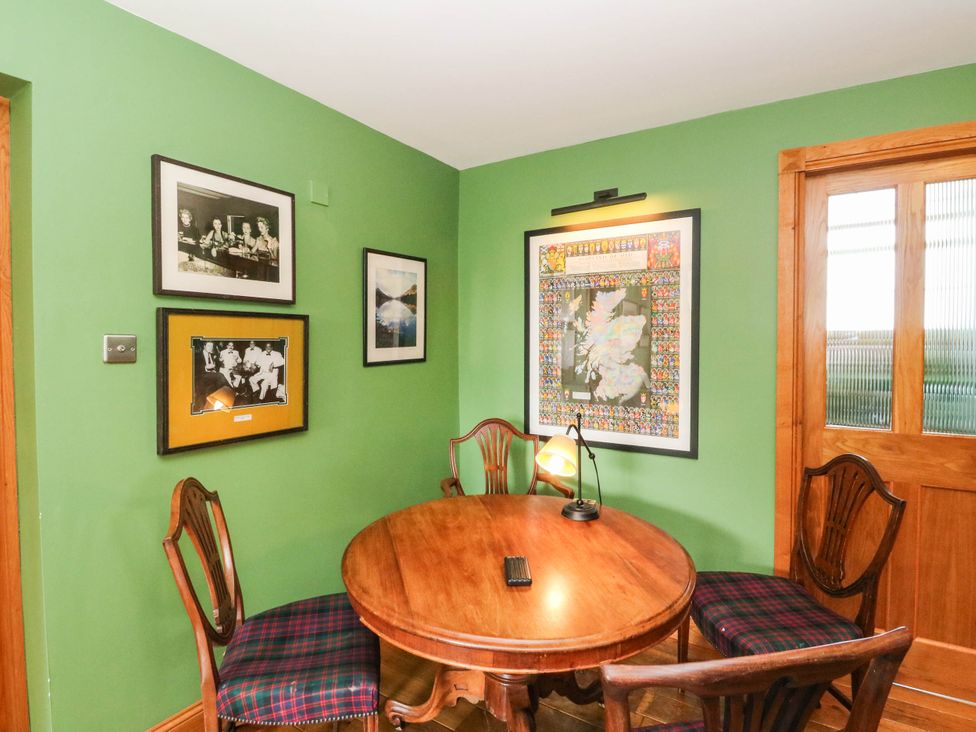 A dining room with a table and chairs at Old School House in Isle Of South Uist