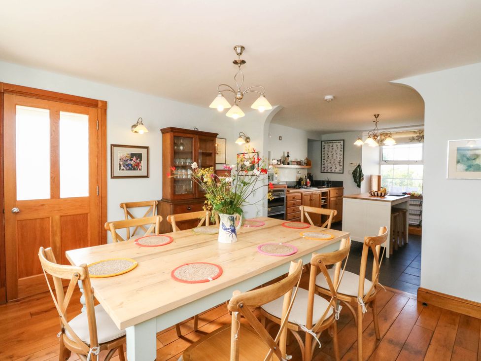 A kitchen with a dining table and chairs at Old School House in Isle Of South Uist