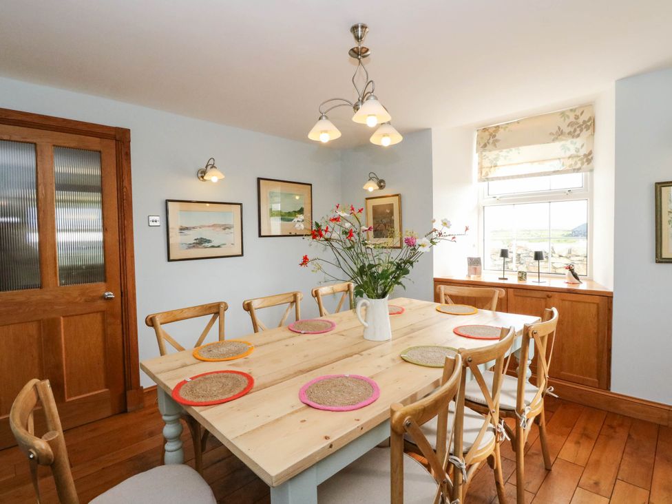 A dining room with a table and chairs at The Old School House Isle Of South Uist