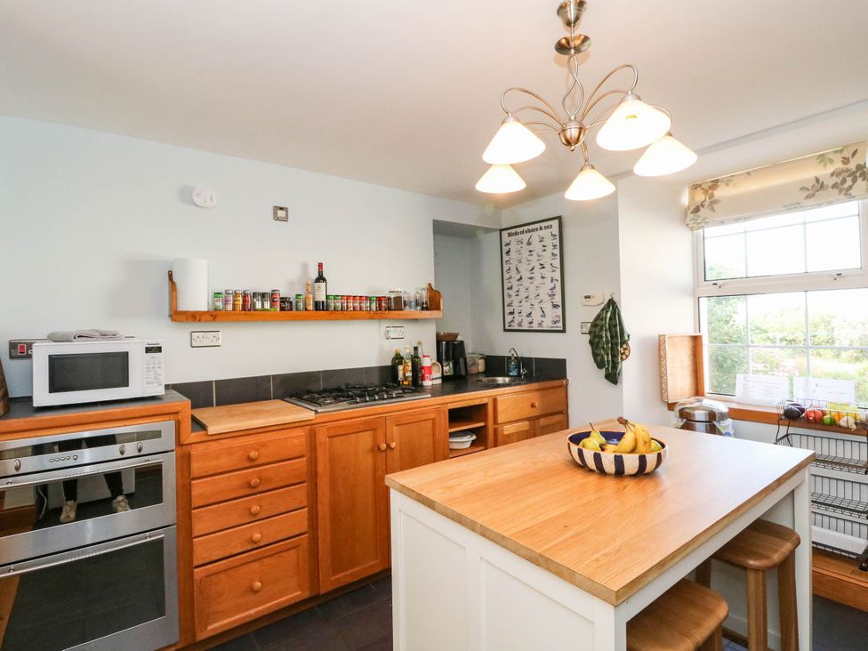 A kitchen with appliances and a fruit bowl at The Old School House in Isle Of South Uist