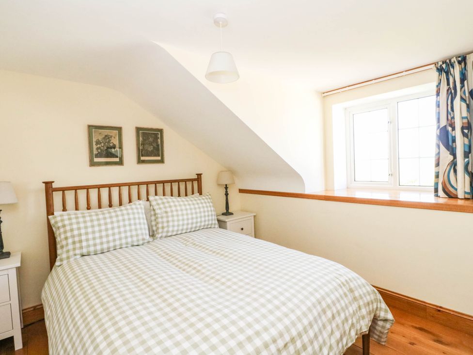 A bedroom with a bed and window at The Old School House Isle Of South Uist