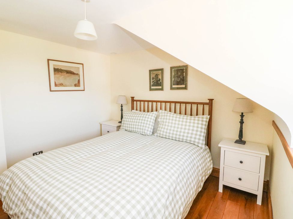 A bedroom with a bed and nightstand at Old School House Isle Of South Uist