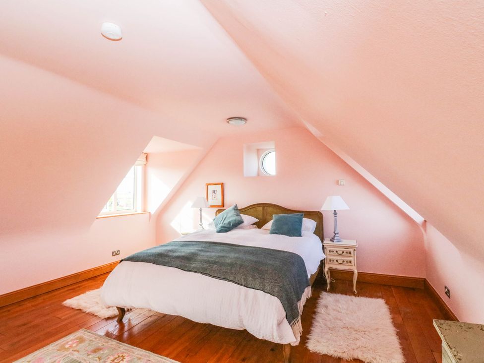A bedroom with a bed and a lamp at The Old School House in Isle Of South Uist