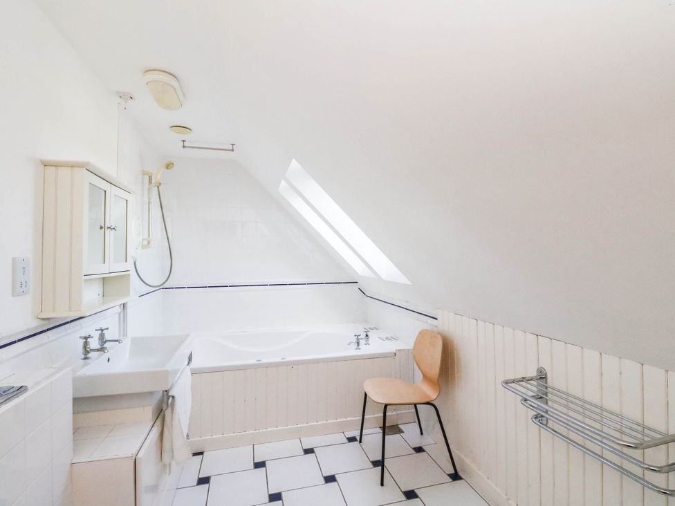 A bathroom with a bathtub, sink, and shower at The Old School House in Isle Of South Uist