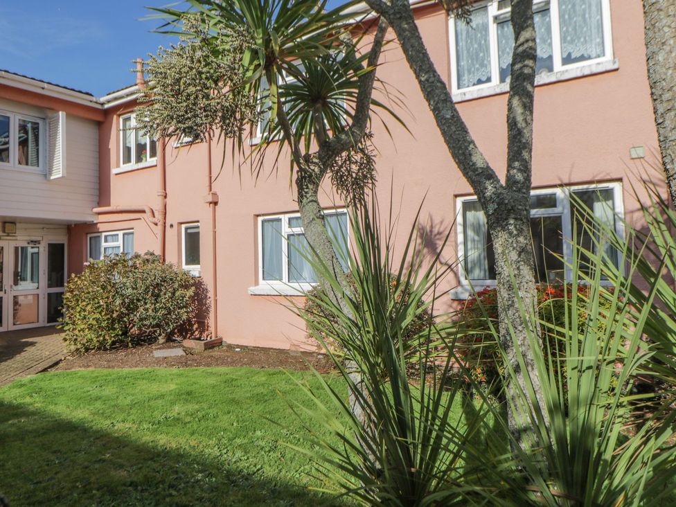 A building exterior with windows and plants at Devon Seaside Apartment in Paignton