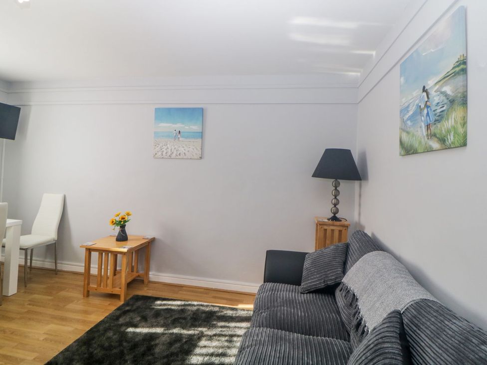 A living room with a sofa and a coffee table at Devon Seaside Apartment in Paignton