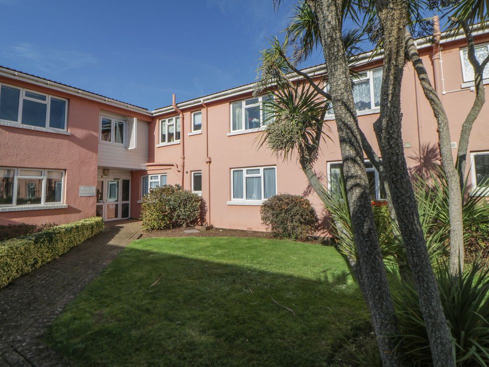 An outdoor view of a building with windows and a pathway at Devon Seaside Apartment in Paignton