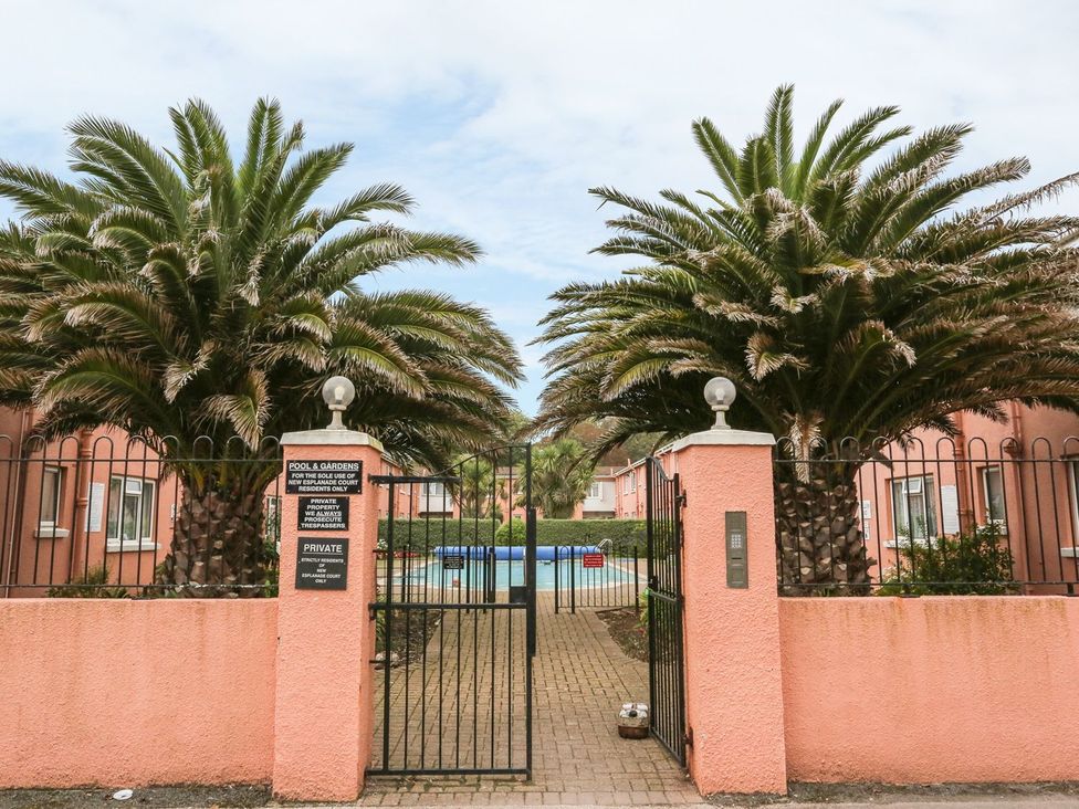 Gates leading to a swimming pool area at Devon Seaside Apartment in Paignton