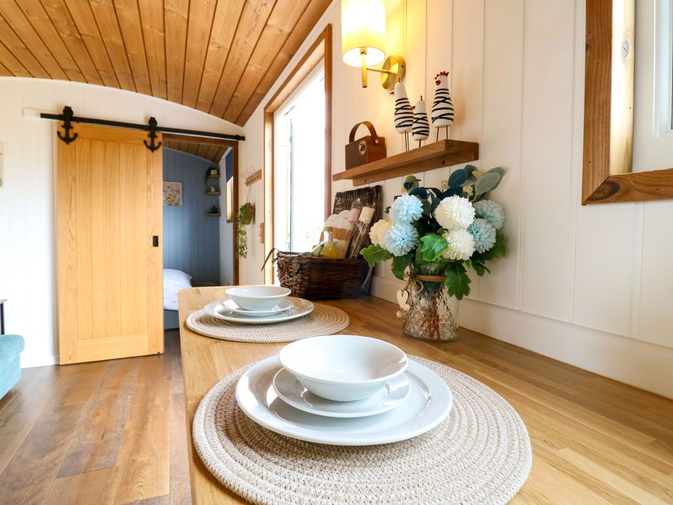 A dining room with plates on a table at The Kestrel in Cambridge