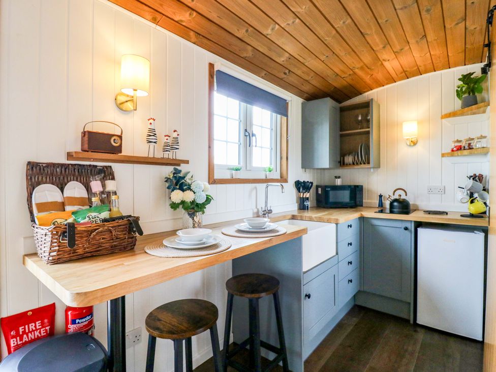 A kitchen with sink and microwave at The Kestrel in Cambridge
