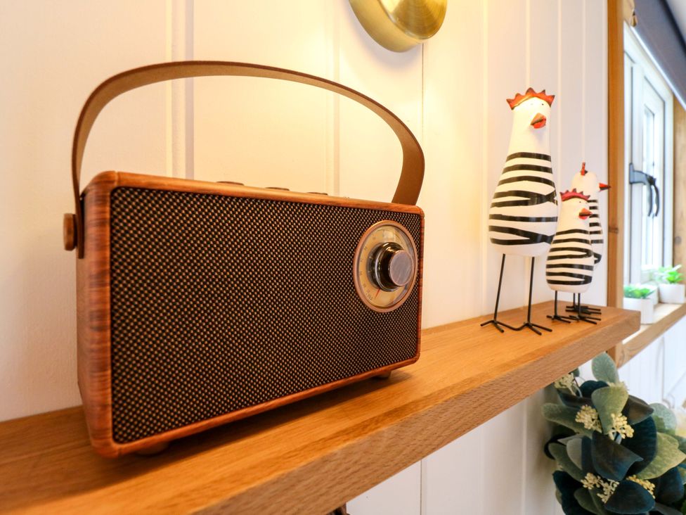 A radio and decorative figures on a shelf at The Kestrel in Cambridge