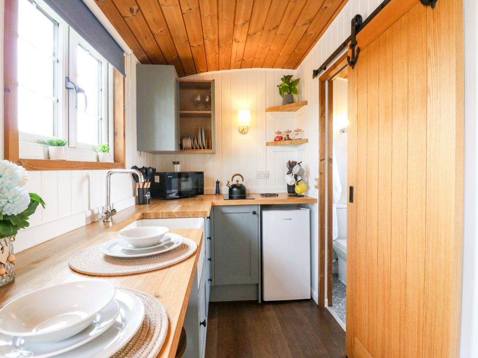 A kitchen with a sink, fridge, and countertop at The Kestrel in Cambridge
