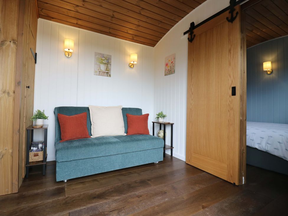 A snug with a sofa and side table at The Kestrel in Cambridge