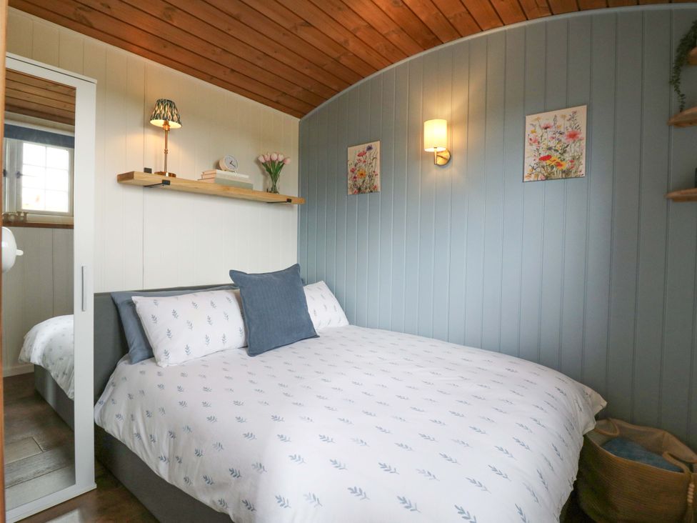 A bedroom with a bed and shelf at The Kestrel in Cambridge