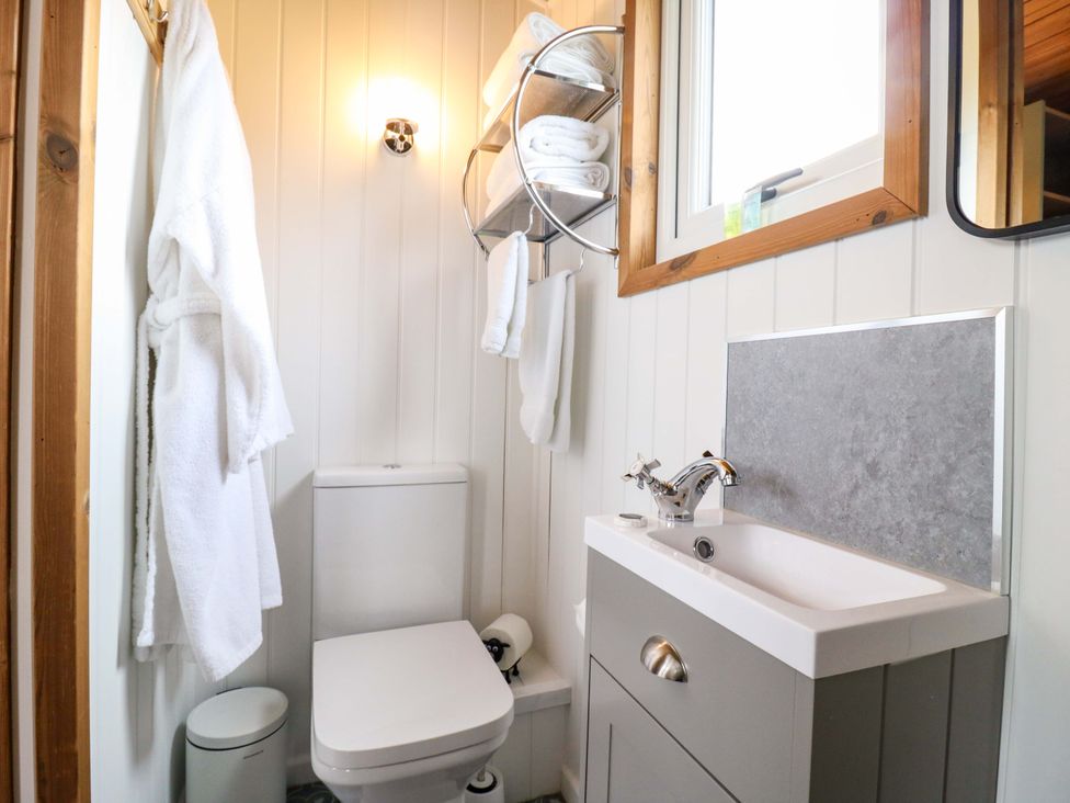 A bathroom with a toilet, sink, and towel rack at The Kestrel in Cambridge