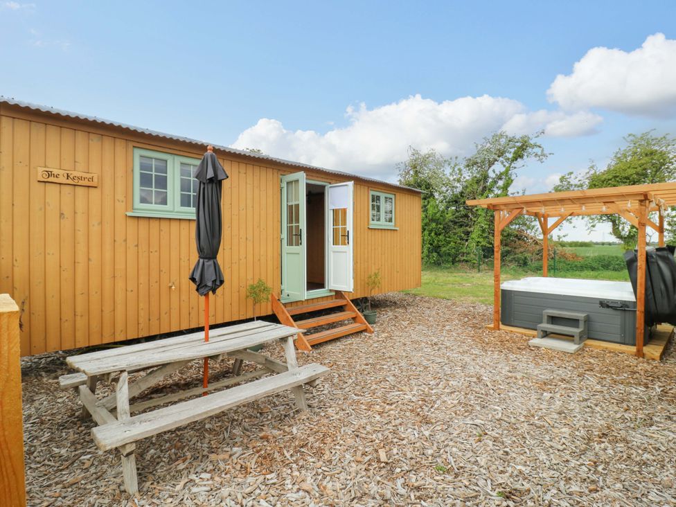 A wooden cabin with steps and a hot tub at The Kestrel in Cambridge