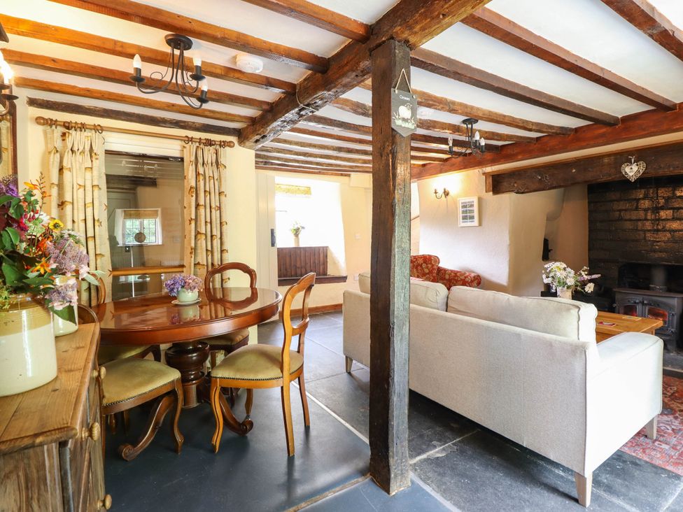 A dining room with wooden table and chairs at Frondirion Dinas Mawddwy