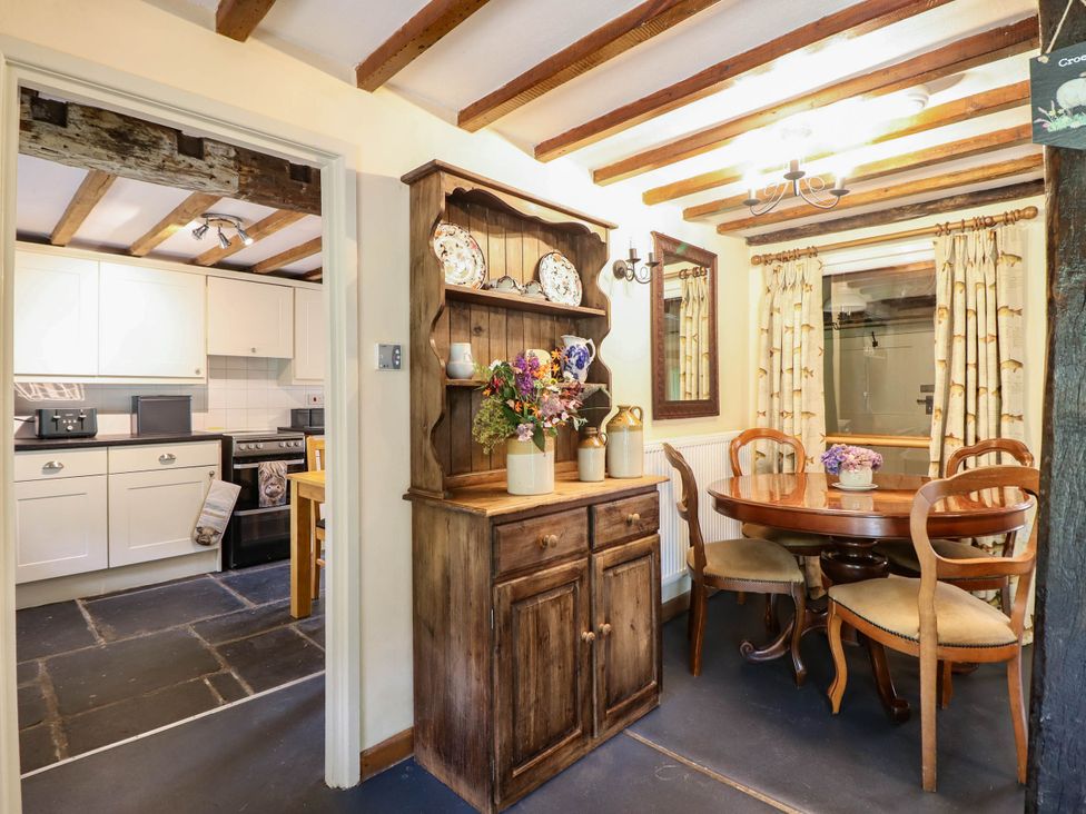 A dining room with a wooden table and chairs at Frondirion in Dinas Mawddwy