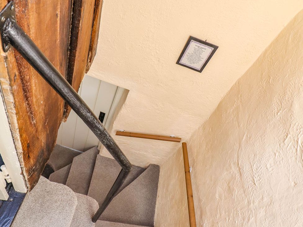 A staircase with handrail and picture frame at Frondirion Dinas Mawddwy