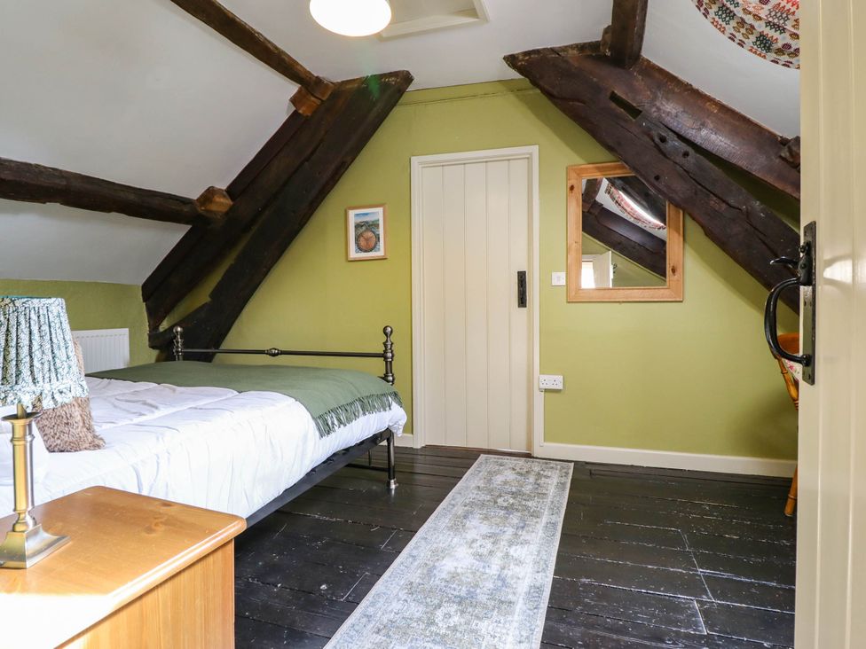 A bedroom with a bed and furniture at Frondirion Dinas Mawddwy