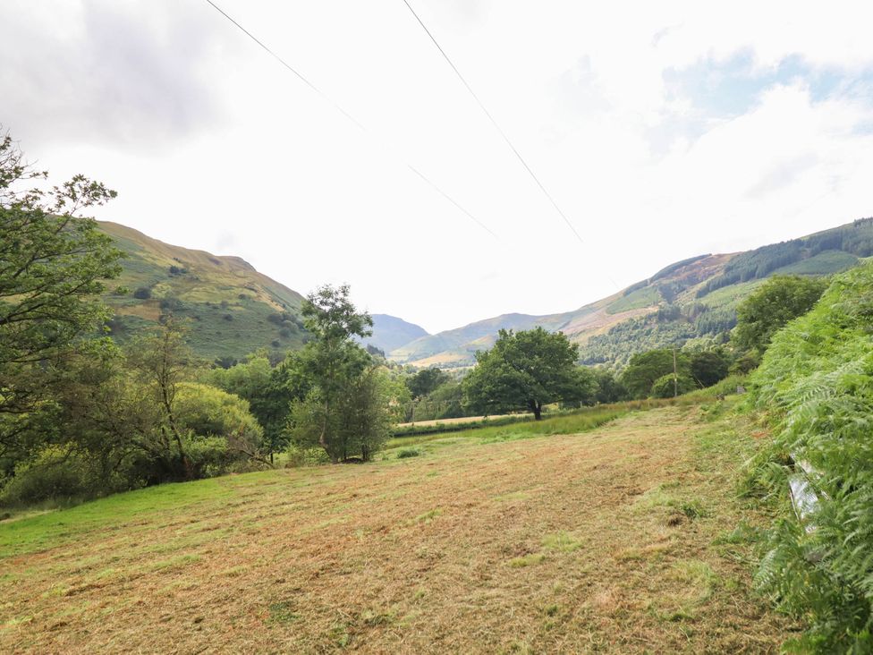 A scenic view of mountains and trees at Frondirion in Dinas Mawddwy