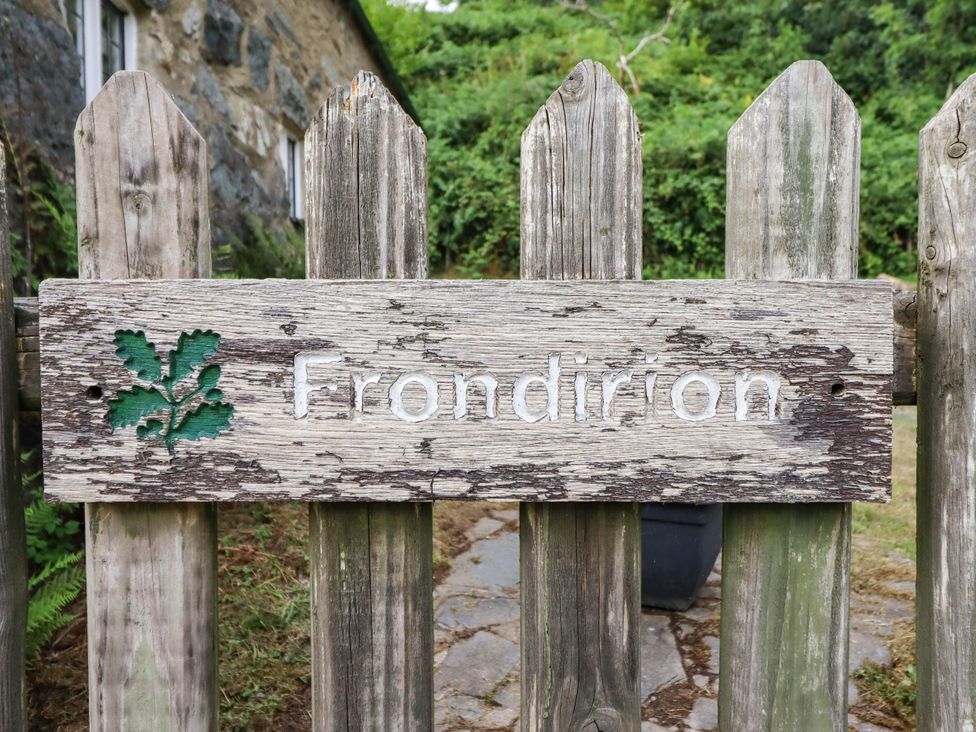 A wooden sign with the name Frondirion on a fence at Frondirion in Dinas Mawddwy