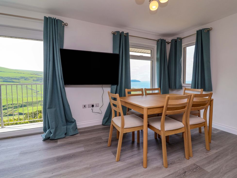 A dining room with a table and chairs at 15 Chichester Park