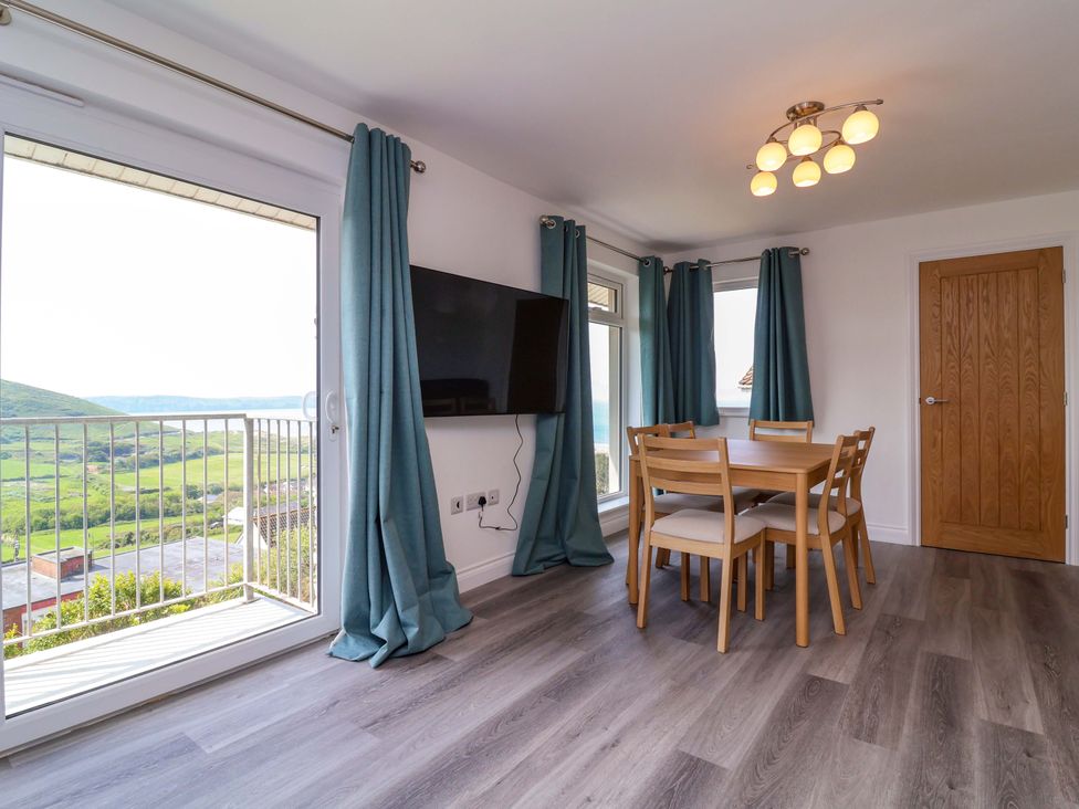 A dining room with a table and chairs at 15 Chichester Park