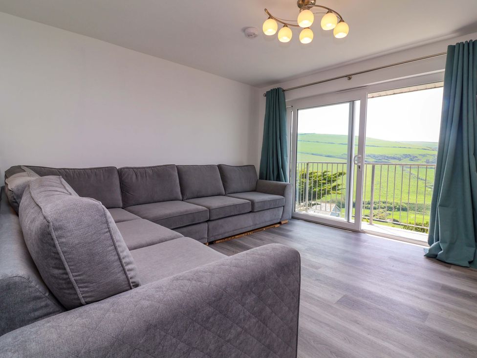 A living room with a sofa and a window at 15 Chichester Park
