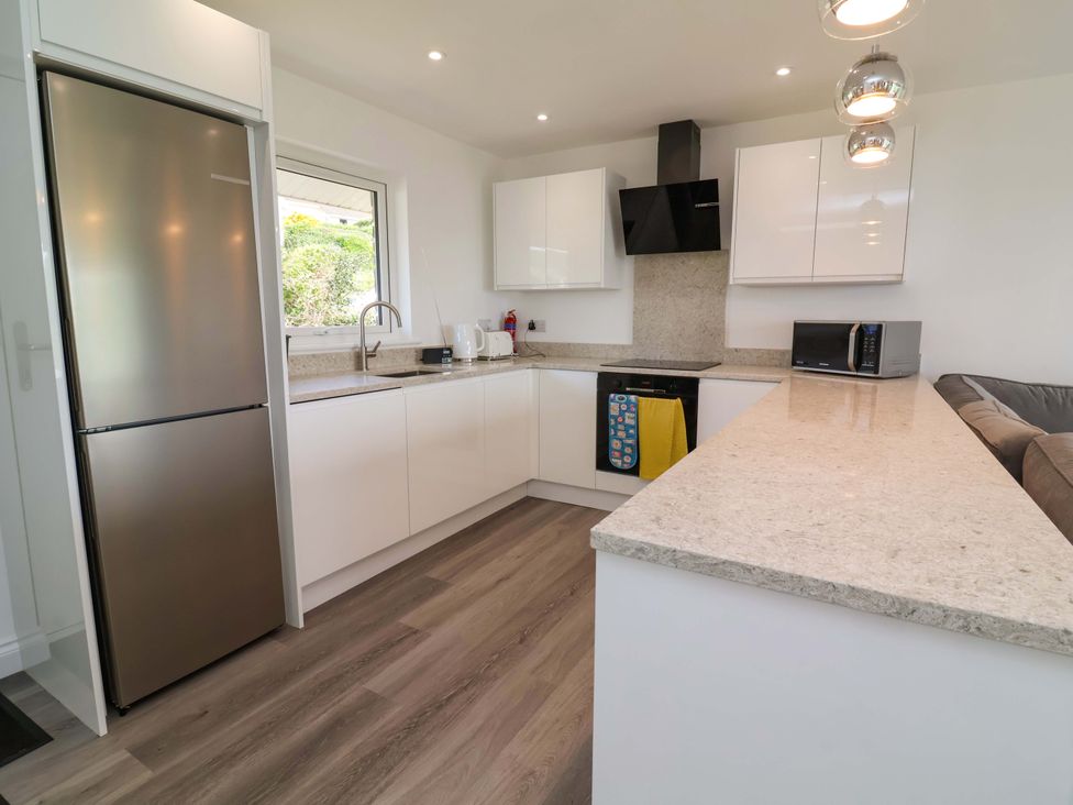 A kitchen with modern appliances and a countertop at 15 Chichester Park