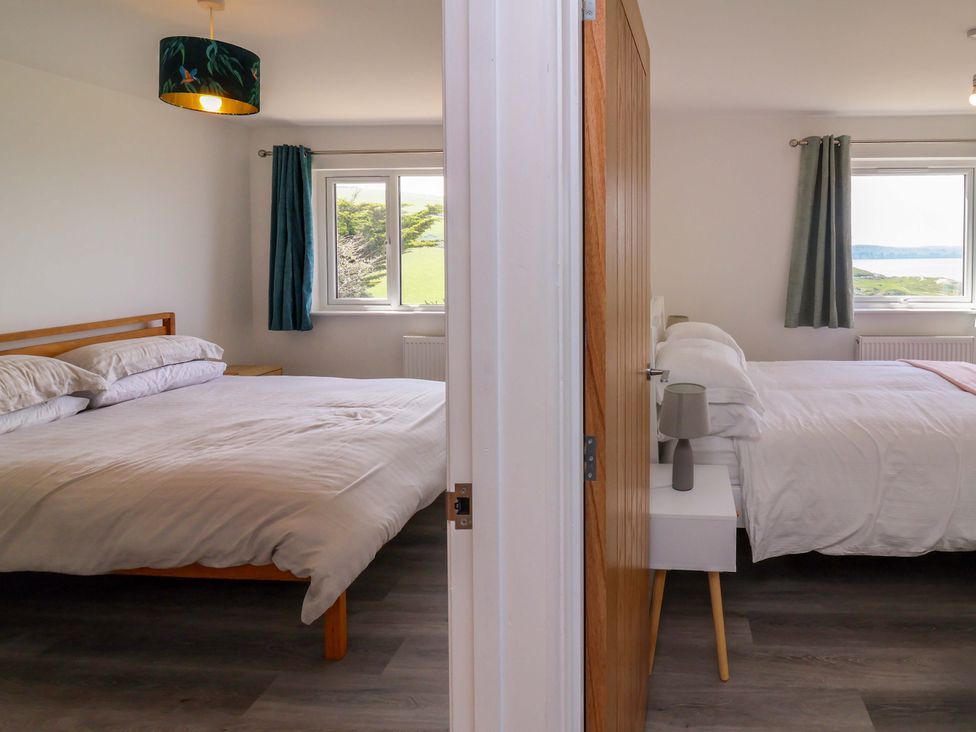 A bedroom with two beds and windows at 15 Chichester Park