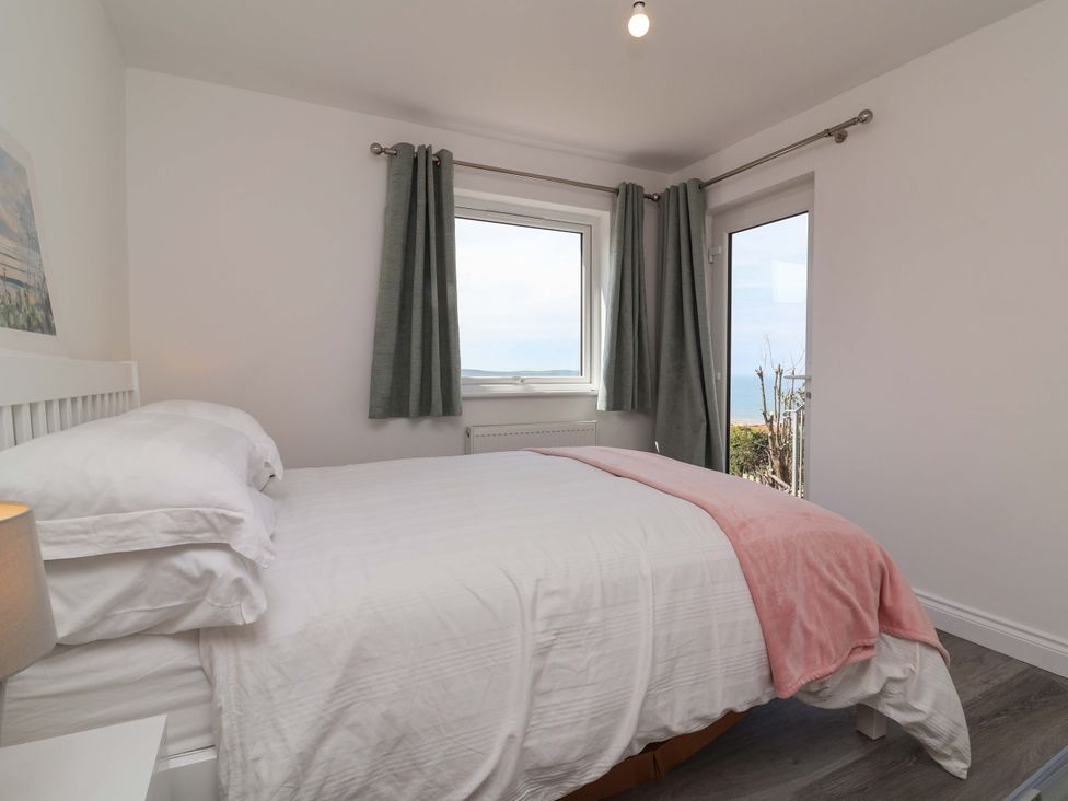 A bedroom with a bed and window at 15 Chichester Park