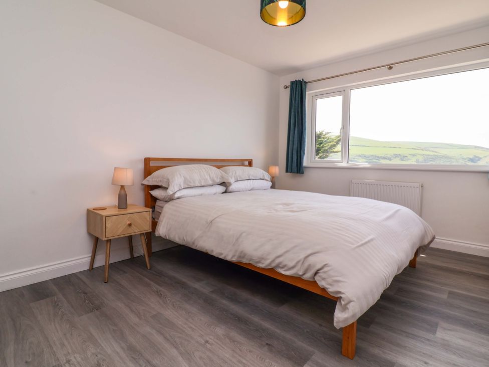 A bedroom with a bed and nightstand at 15 Chichester Park