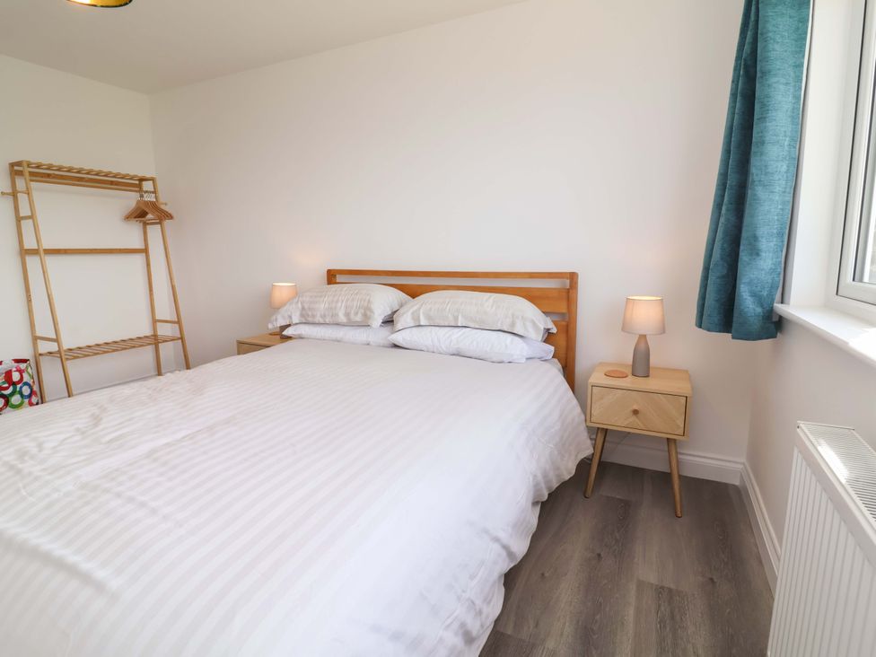 A bedroom with a bed and nightstands at 15 Chichester Park