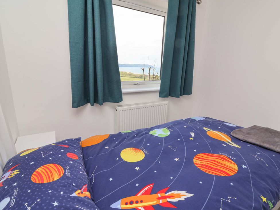 A bedroom with a bed and window at 15 Chichester Park