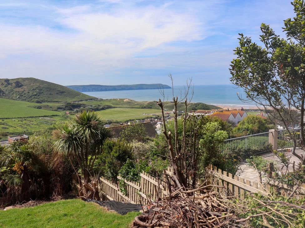 A view of ocean and hills with houses in the foreground at 15 Chichester Park