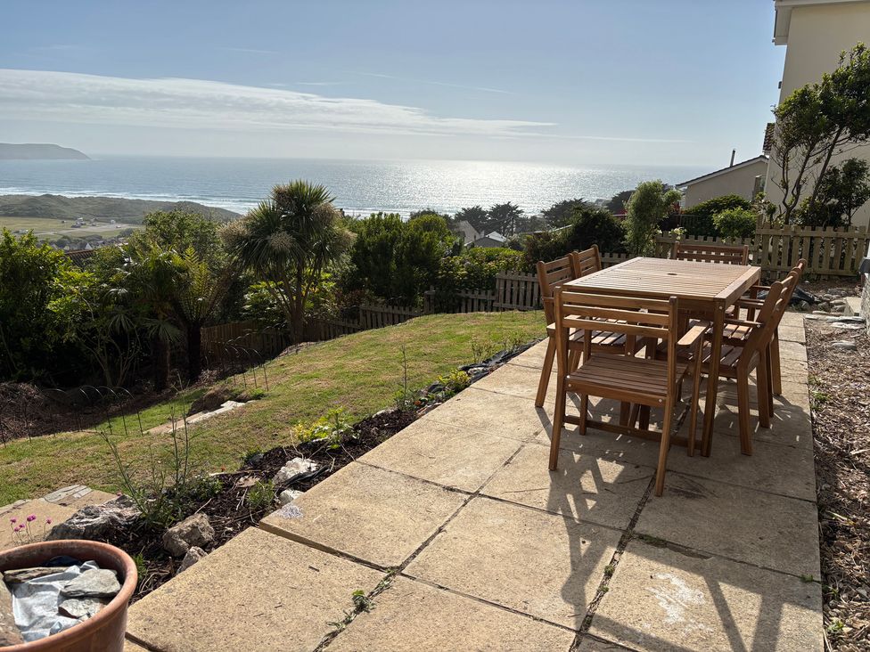 A garden with table and chairs overlooking the sea at Belvedere in Woolacombe