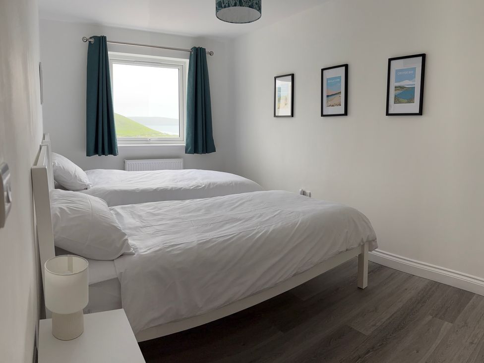 A bedroom with two beds and a window at Belvedere in Woolacombe