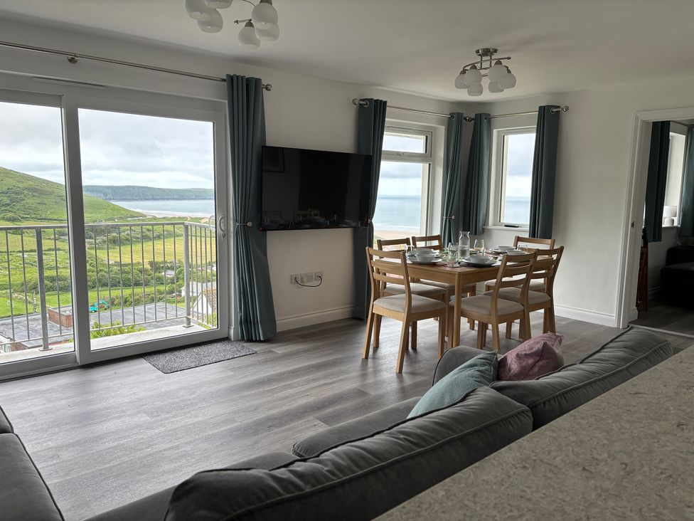 A living room with a dining area and view at Belvedere in Woolacombe