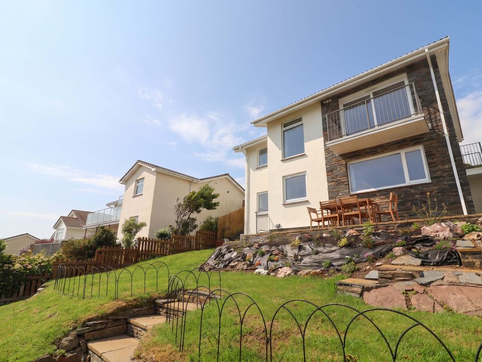 Two houses with a garden and outdoor seating area at Belvedere Woolacombe