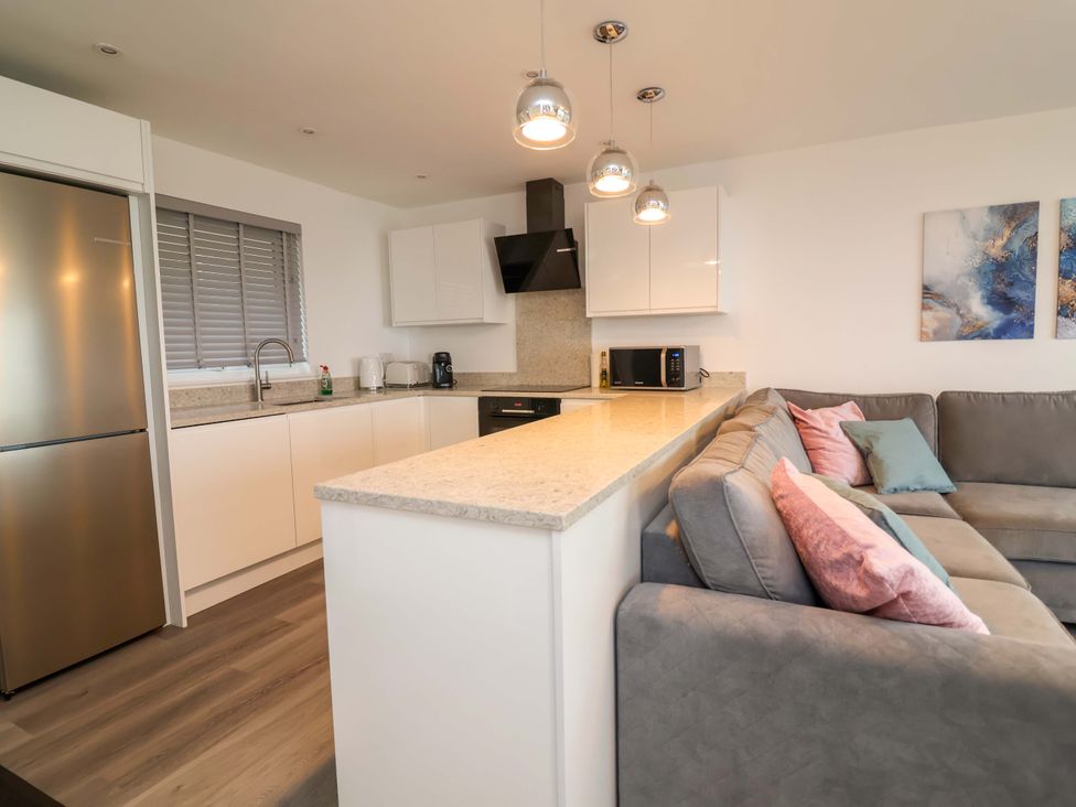 A kitchen with a refrigerator and sink at Belvedere Woolacombe