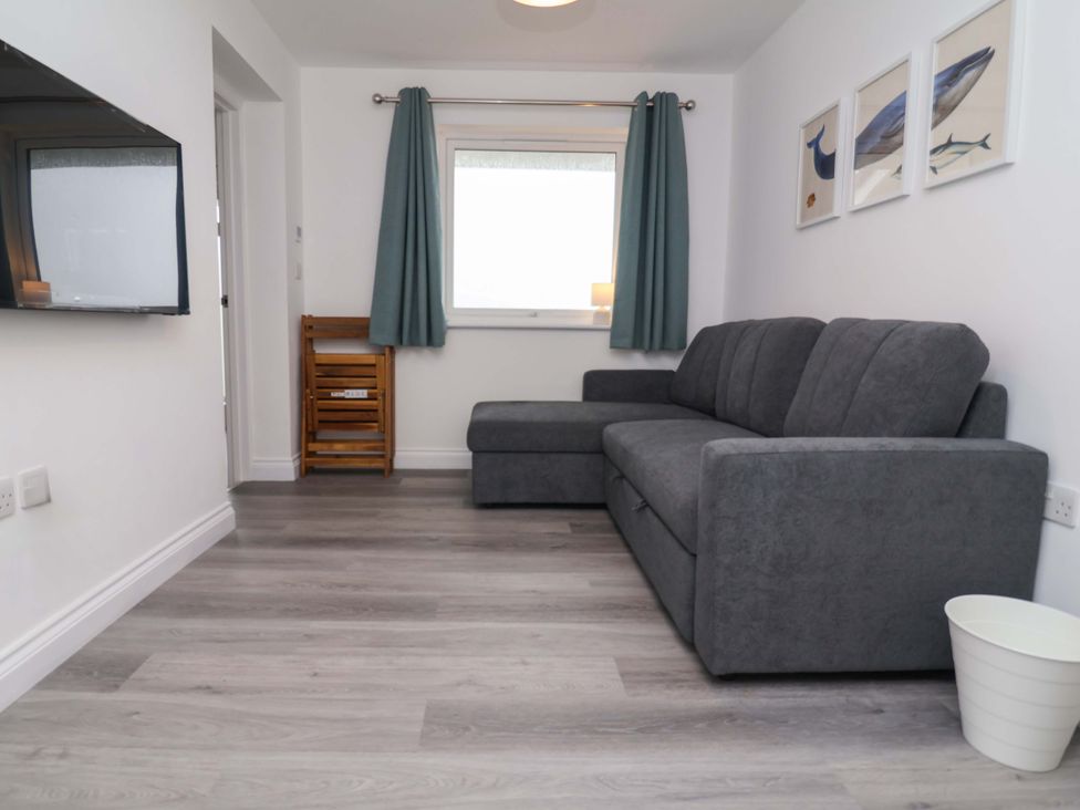 A living room with a sofa and television at Belvedere in Woolacombe